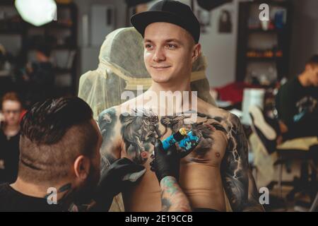 Young man with tattoos on arms against white background Stock Photo  Alamy
