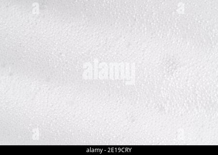 White foamy cleansing skin care product texture from soap, detergent, shampoo, shaving foam or cleanser. Soapy surface closeup. Foam macro background Stock Photo