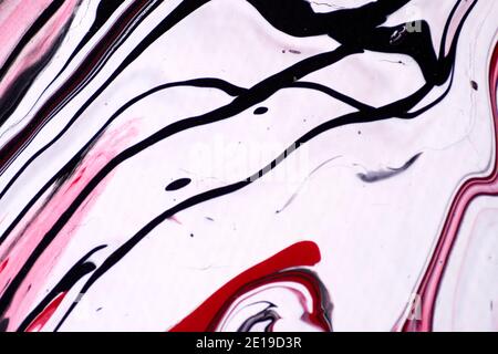 Marbled acrylic colored pattern in the colors red, black, white and pink Stock Photo