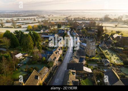 Aerial drone photo of a quiet empty roads during Coronavirus Covid 19 pandemic lockdown in a Cotswolds Village in England, English rural scene with countryside and fields, Gloucestershire Stock Photo