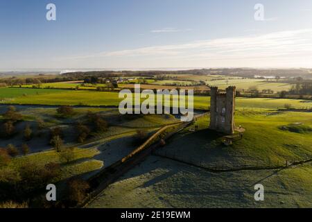 Aerial drone photo of Broadway Tower, a famous old building landmark in The Cotswolds Hills, iconic English tourist attraction in beautiful British countryside with green fields, Gloucestershire, England, UK Stock Photo