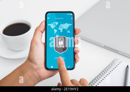 Point of view of woman using smartphone with vpn app Stock Photo