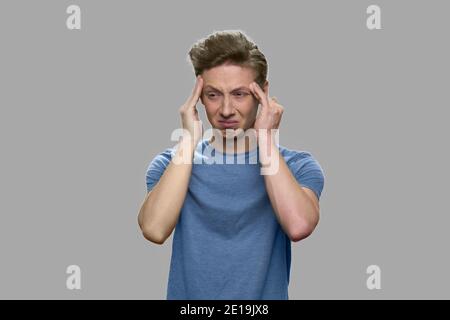 Portrait of teen boy suffers from headache. Stock Photo