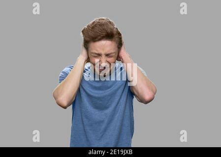 Teenage guy suffering from severe headache. Stock Photo