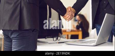 Close-up of business partners making deal and shaking hands to confirm collaboration Stock Photo