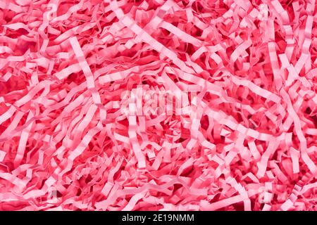 Texture of shredded pink paper packing material. Background for copy space Stock Photo