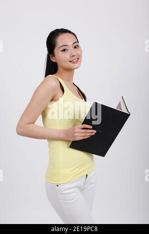 A young beauty lady holding a book high quality photo Stock Photo