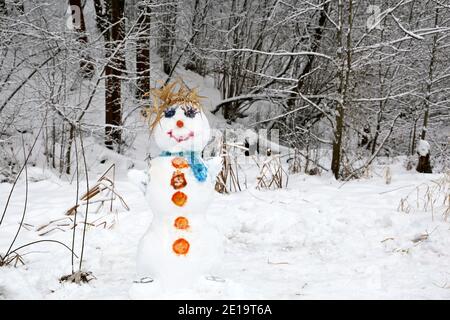 Funny snowman in a winter park. Children's creativity, leisure at cold weather Stock Photo