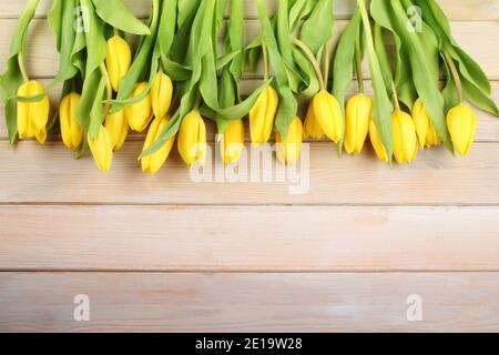 Easter background with yellow tulips on a wooden table Stock Photo