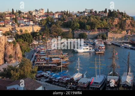 Yachts and trip boats in the port of Antalya, Turkey. The port is surrounded by city walls erected in Byzantine era Stock Photo