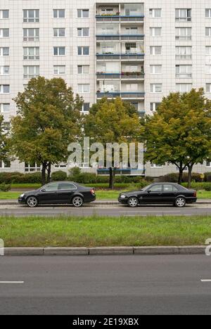 residential building and two black cars parked in  Karl Marx Allee, Berlin, Germany