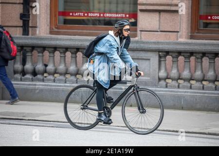 woman on a bike in denim Stock Photo