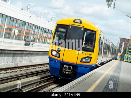 London,England:17 Jul,2012.  A train arrives at Haggerston Overground train Station in the London Borough of Hackney, East London. Hagerstown is a zon Stock Photo