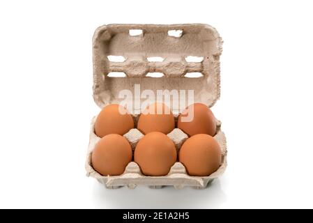 Egg box with eggs, six chicken eggs in cardboard egg tray made from recycled paper isolated on white background Stock Photo