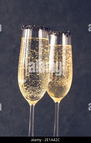 Flutes of champagne with black caviar rim Stock Photo