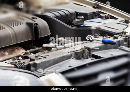 Cropped image of automobile mechanic repairing car in automobile store Stock Photo