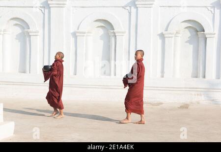 Novice monks returning to Shwe Yan Pyay Monastery after collecting alms. Stock Photo