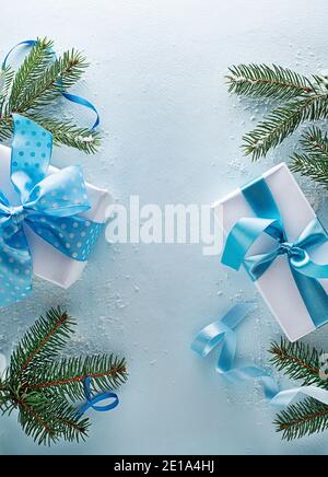 Holidays blue winter background with fir tree and gift box. Top view with copy space Stock Photo