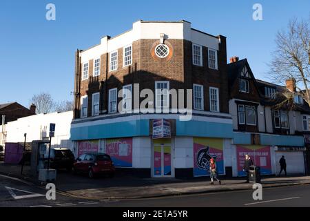 On the last day of the year, the Argos shop on Kings Heath High Street is closed down, with shutters down due to Tier Four coronavirus restrictions on 31st December 2020 in Birmingham, United Kingdom. Small businesses have struggled through the Covid-19 pandemic and many have closed down altogether, as the recession in the economy deepens as the crisis continues. Stock Photo