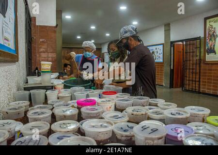 Through a numbering system, all people who require food are given a number, and then removed from their food supply. The solidarity pot is a social pr Stock Photo