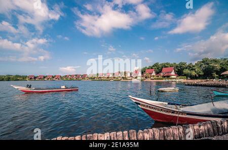 Fishing boats near its docking places, some of them are parked and tied on the dock Stock Photo