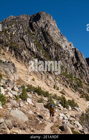 WA18987-00...WASHINGTON - Hiker approaching Cathedral Pass on the Boundary Trail in the Pasayten Wilderness. Stock Photo