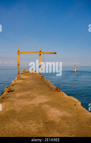 Fishing boats near its docking places, some of them are parked and tied on the dock Stock Photo