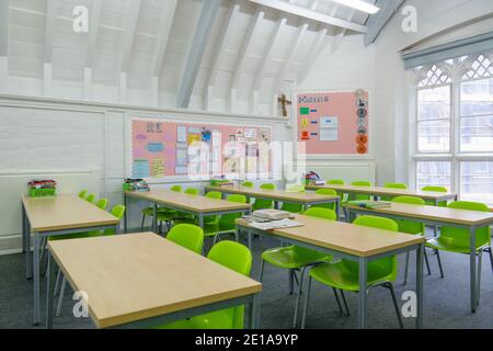 Typical primary / middle school classroom in the UK with desks and chairs in rows. Schools closed in lockdown but prepared for reopening in March 2021 Stock Photo
