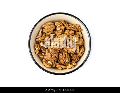 Peeled walnuts in a brown bowl on a white background. Stock Photo