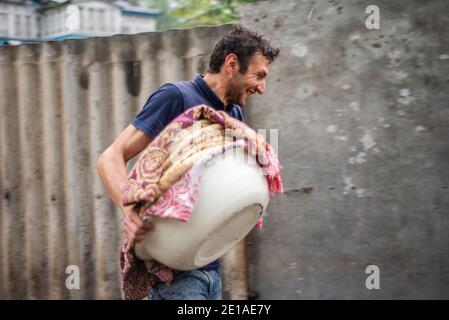 A man carries freshly baked traditional Lezgi bread in Khazra village, Qusar district, Azerbaijan Stock Photo