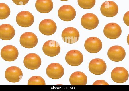 Pattern made of whole ripe ruby grapefruit on white background Stock Photo