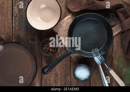 Empty dishes, frying pan, plates on a wooden background. Stock Photo