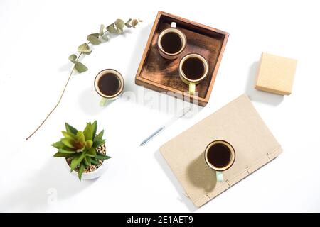 Mango wood wooden tray with four espresso coffee cups on the white background. Empty space Stock Photo