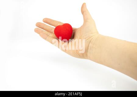 Red heart in a hand on white background Stock Photo
