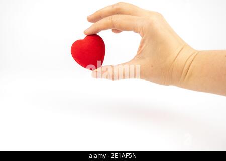 Red heart in a hand on white background Stock Photo