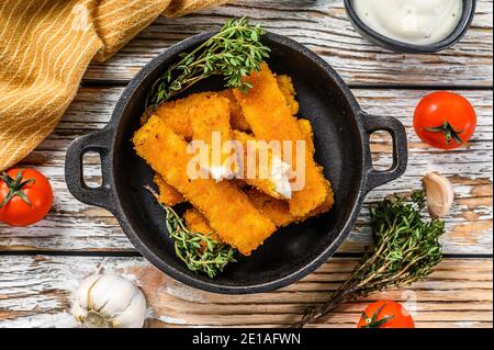 Oven baked crumbed fish sticks made from white fish. White background. Top view Stock Photo