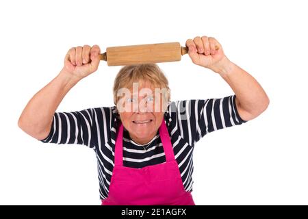 Very angry elder woman with pin roller isolated over white background Stock Photo