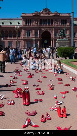 Red shoes feminist protest outside the Casa Rosada (Pink House) Presidential Palace, Buenos Aires, Argentina Stock Photo