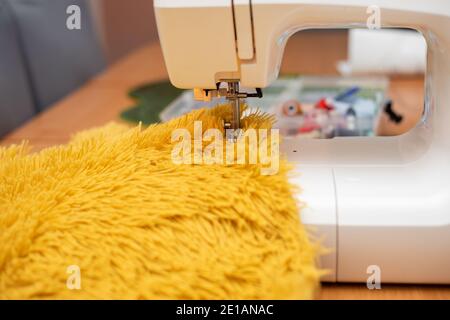 sew fur on sewing machine. close-up photo Stock Photo