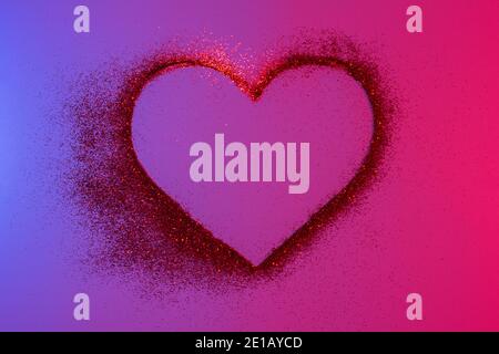 Happy Valentine's Day. Heart of red bright sparkles and glitter in pink-blue neon lights.Artistic design colorful and shiny bright background Stock Photo
