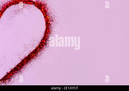 Half red defocused glitter heart on pink background .Valentines day concept.Copy space Stock Photo