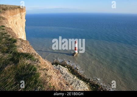 Beachy Head lighthouse looks so small when seen from the top of the cliffs on England's south coast. The headland rises to 162 metres (531 ft). Stock Photo