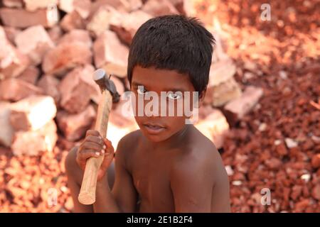 Dhaka, Bangladesh. 05th Jan, 2021. 8 year old Junaed Hossain looks on as he works at a brick breaking yard in Dhaka.Child labourers in Bangladesh earn around BDT 150 ($1.87) per day. Credit: SOPA Images Limited/Alamy Live News Stock Photo