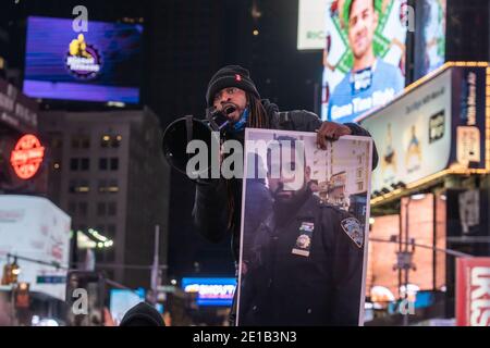 NEW YORK, NY - JANUARY 5: An activist speaks to protester gather in Times Square on January 5, 2021 in New York City.  A small group of 20 protestors march after the announcement in the Jacob Blake case.  Kenosha County District Attorney Michael Graveley announced Tuesday that Rusten Sheskey, a White Police Officer, who shot Jacob Blake, a 29-year-old Black man, seven times in the back while responding to a domestic incident on August 23, 2020, will not face charges in the shooting. Credit: Ron Adar/Alamy Live News Stock Photo