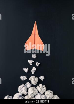 Launching paper rocket with jet stream of paper balls, creativity concept or new ideas metaphor, start up business , new year’s resolution Stock Photo