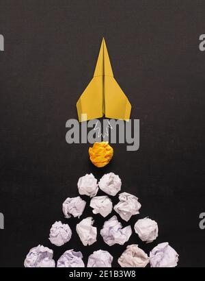 Launching paper rocket with jet stream of paper balls, creativity concept or new ideas metaphor, start up business , new year’s resolution Stock Photo