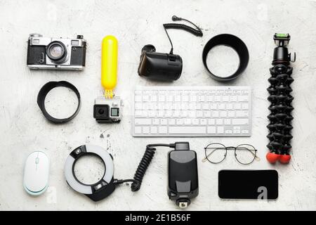Composition with modern photographer's equipment and computer keyboard on light background Stock Photo