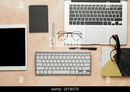 Composition with computer keyboard and different modern devices on color background Stock Photo