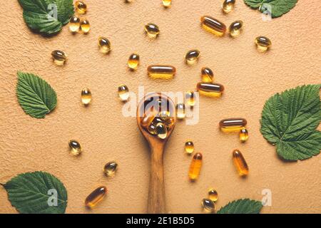 Composition with fish oil capsules on color background Stock Photo
