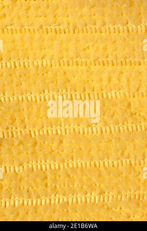 Fabric yellow striped background. Soft fiber texture polyester close-up. fine grain fabric. Stock Photo